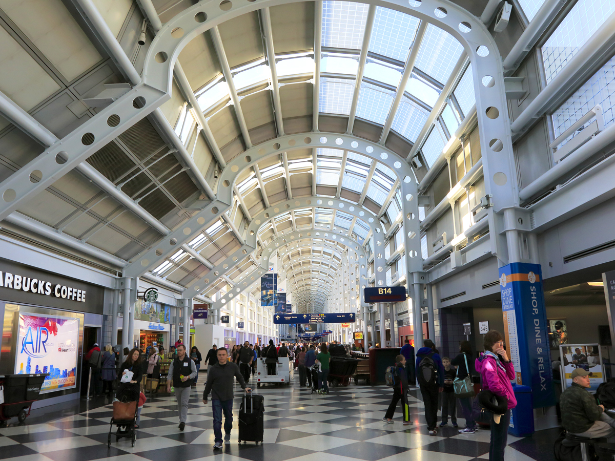 Passengers walking past concessions at Chicago O'Hare International Airport
