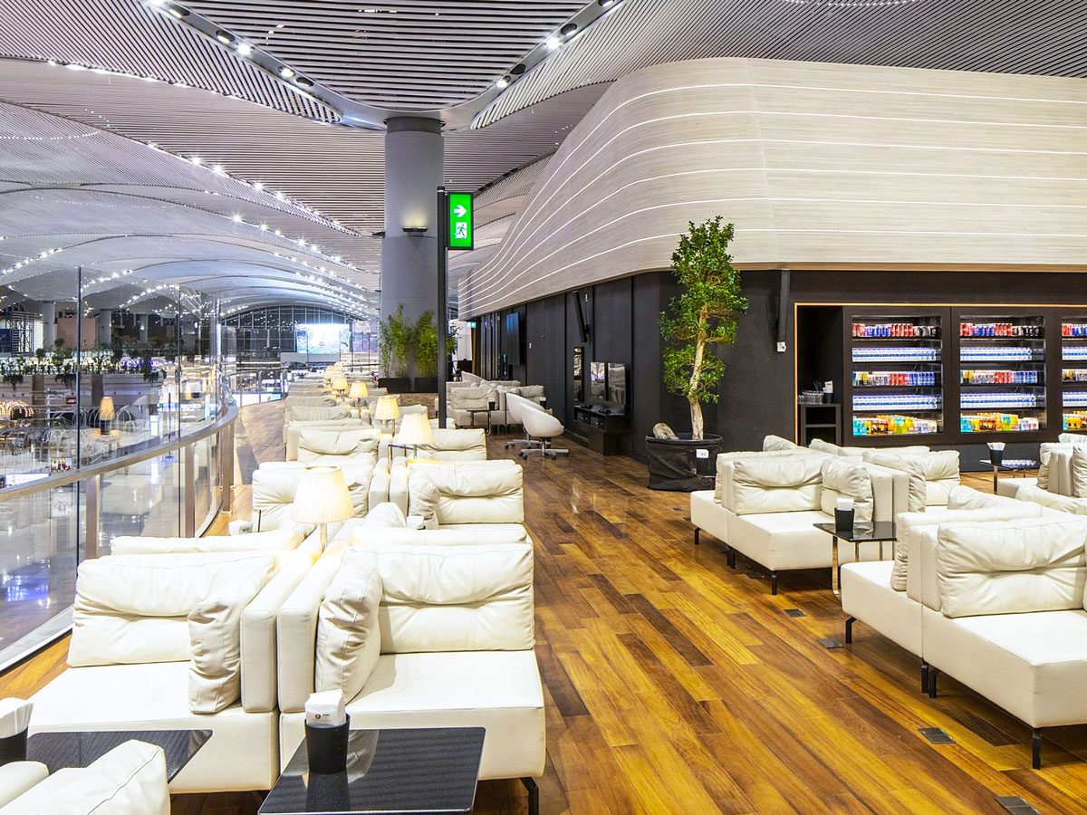 Plush seating in Turkish Airlines Business Class Lounge overlooking terminal at Istanbul Airport