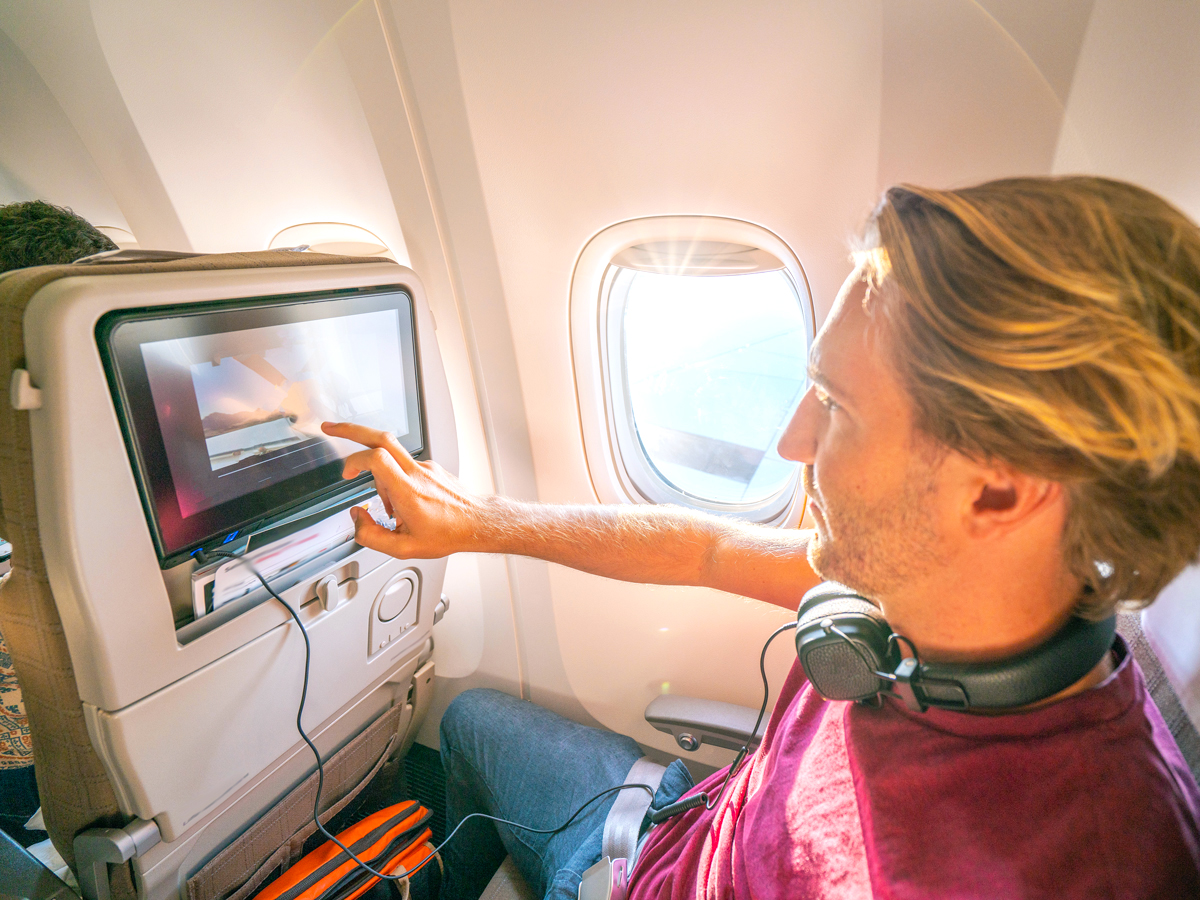 Passenger navigating seatback entertainment screen