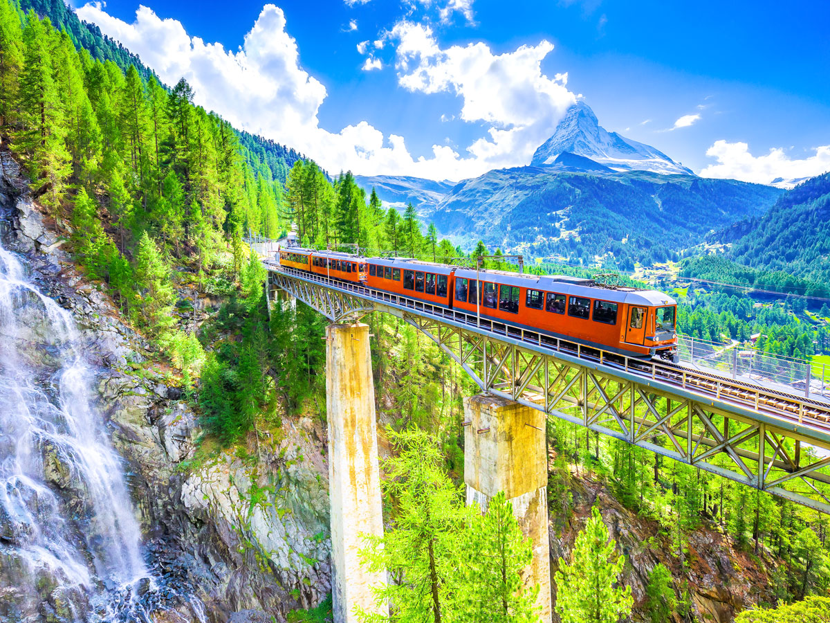 Train on bridge high over mountain pass in Zermatt, Switzerland