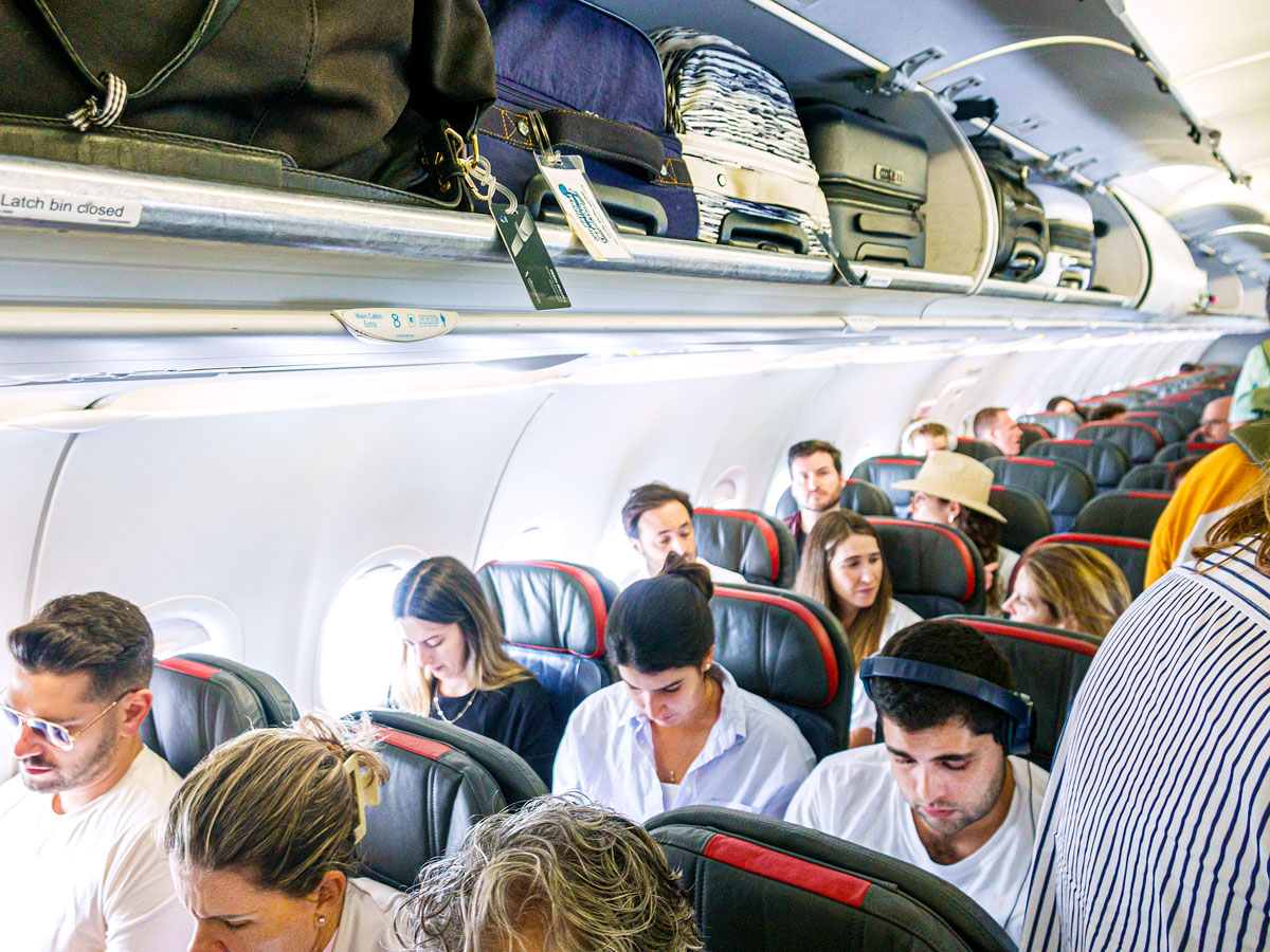 Passengers boarding American Airlines aircraft economy class