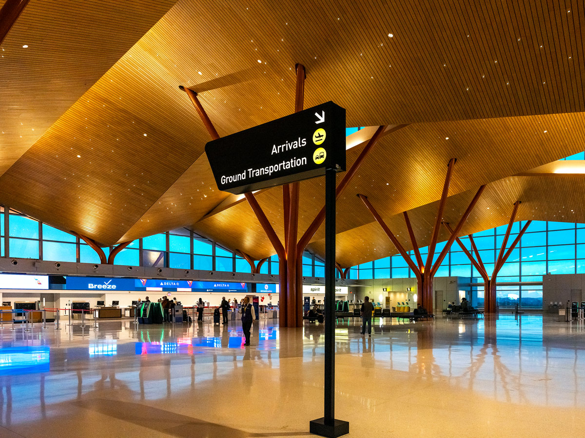 Wayfinding sign underneath soaring terminal ceiling at Pittsburgh Airport