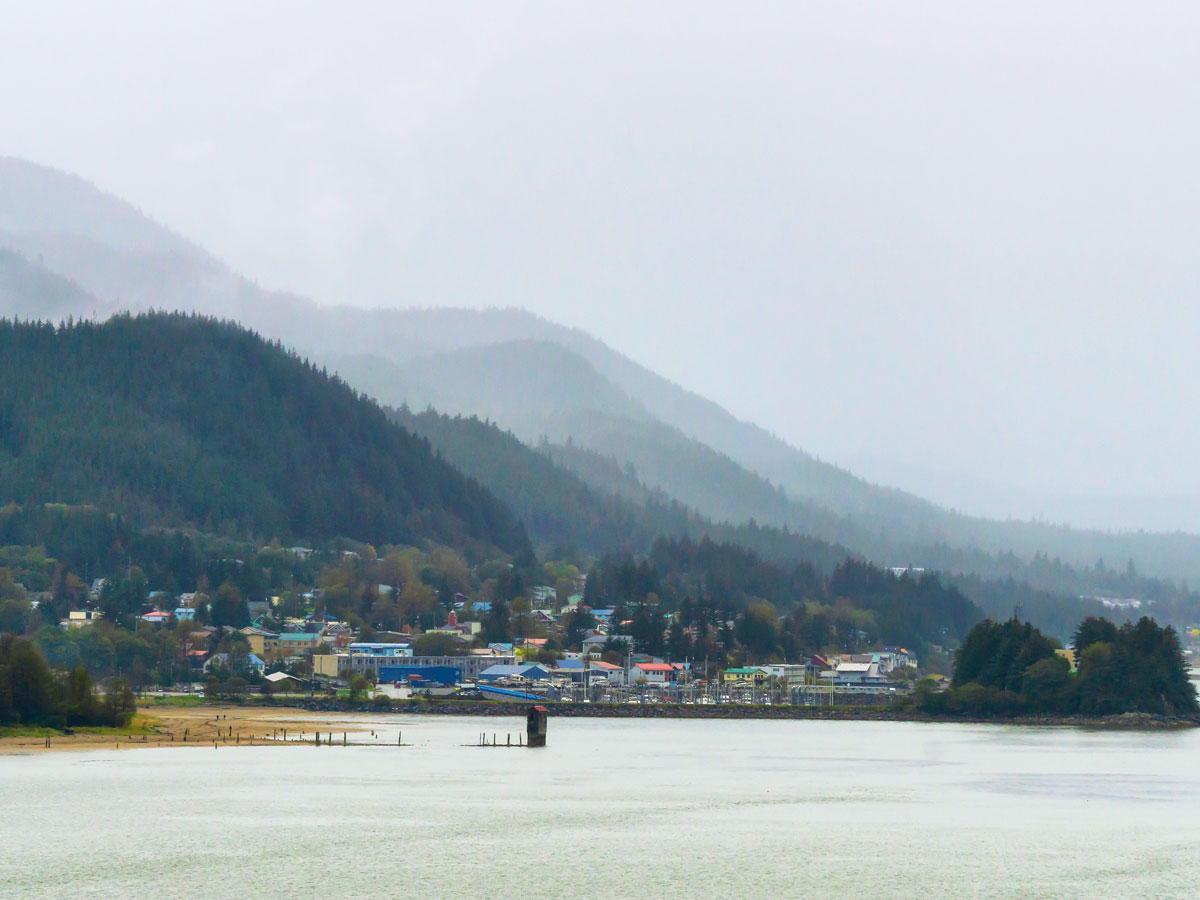 Cloud-covered mountains and beach in Juneau, Alaska