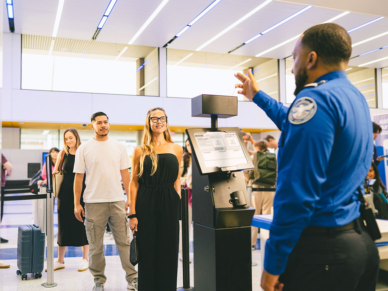 Travelers having biometric photos taken in TSA's Touchless ID lane