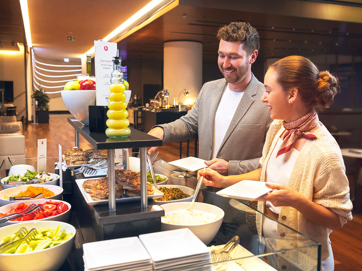 Passengers visiting buffet inside Turkish Airlines Lounge