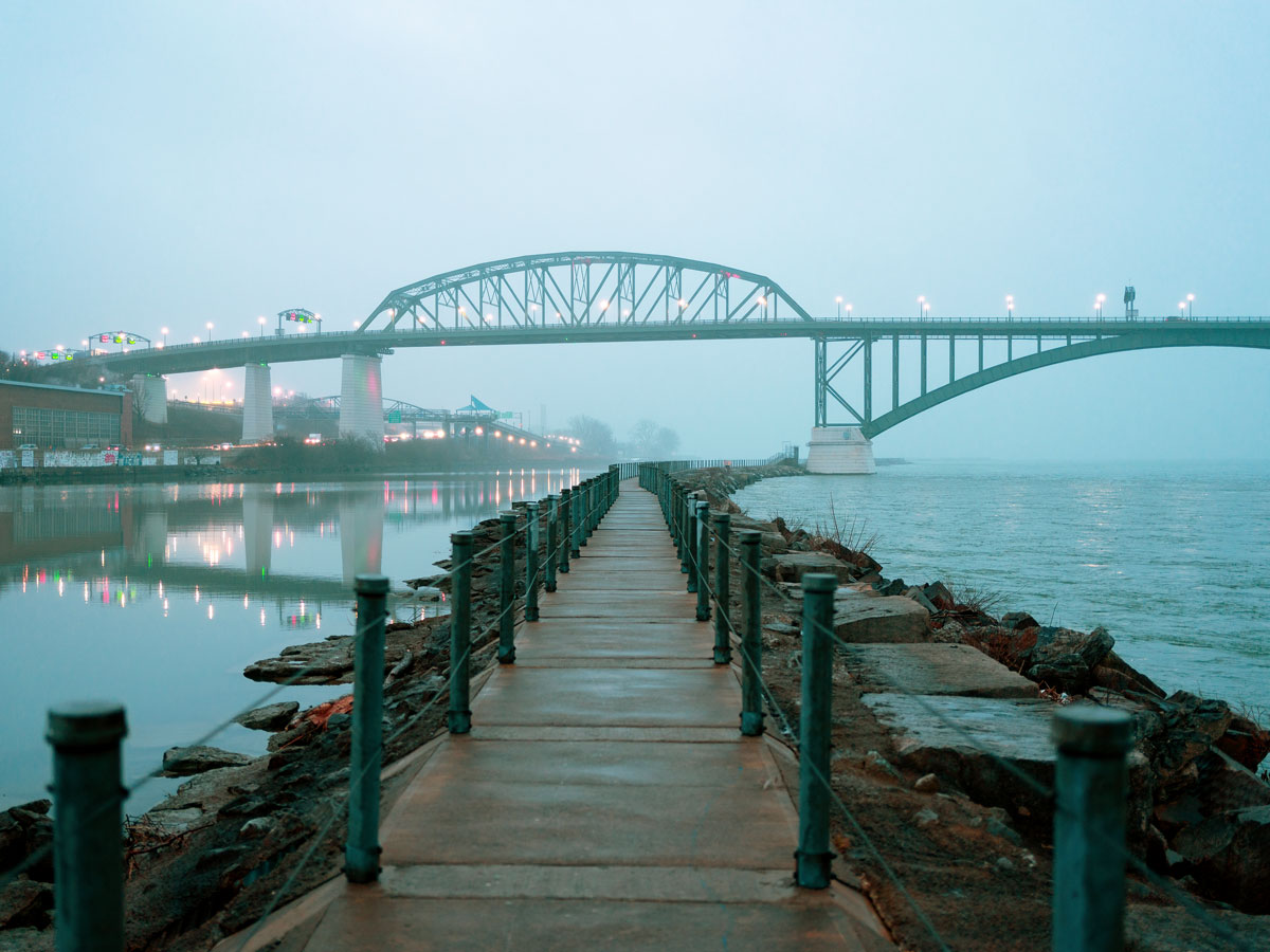 Waterfront path and bridge under cloudy skies in Buffalo, New York