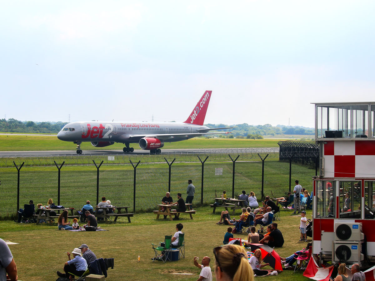 People gathered at Runway Visitor Park at Manchester International Airport in England