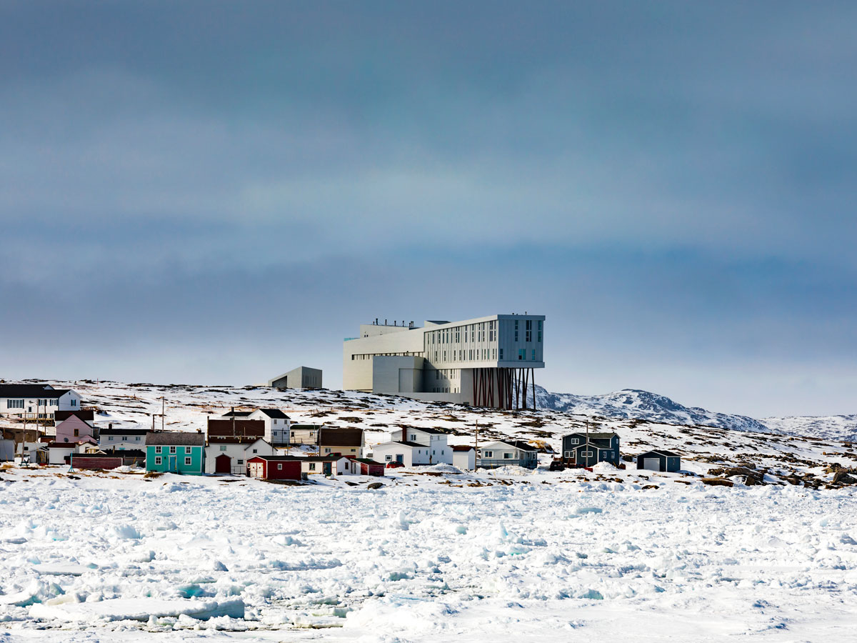 View of Fogo Island inn in the distance across snowy landscape