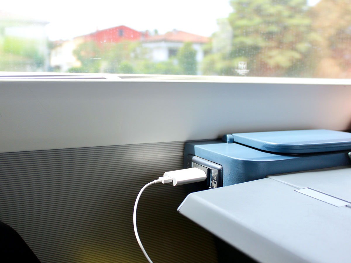 Charger plugged into outlet next to train window