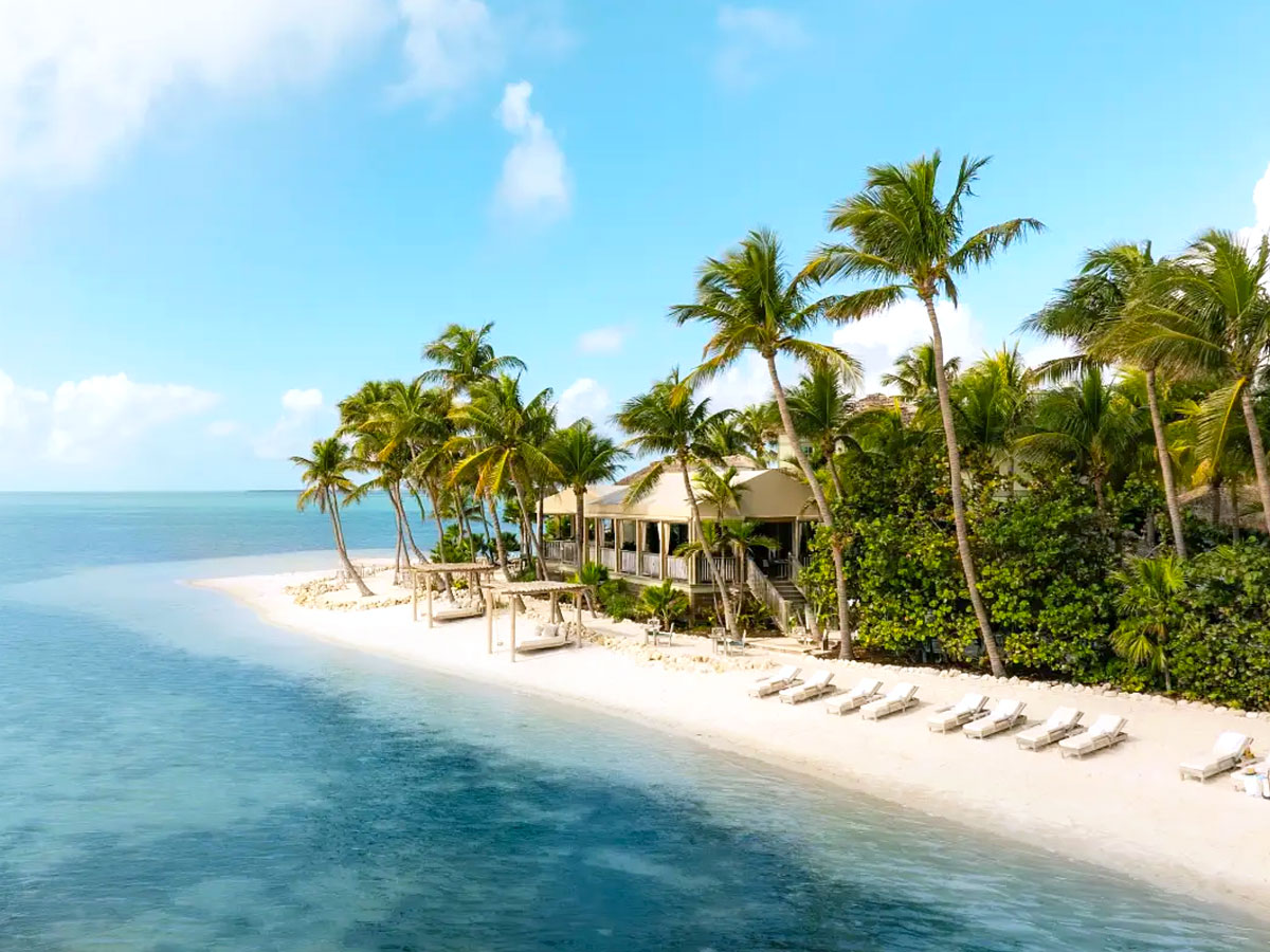 Cabanas and lounge chairs on beach of Little Palm Island Resort in the Florida Keys