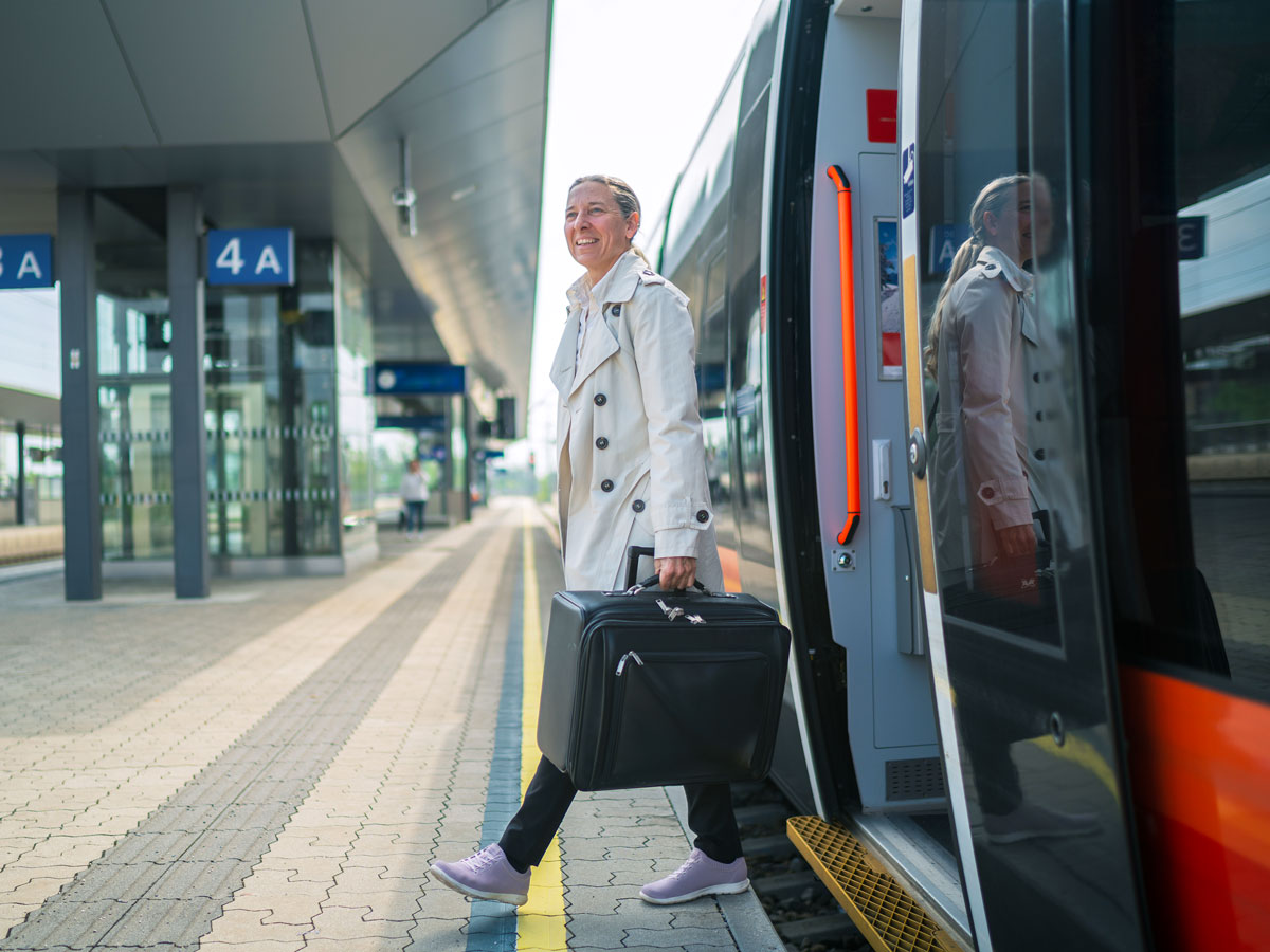Passenger stepping off train onto platform
