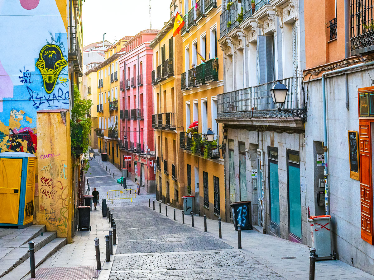 Empty pedestrian street with colorful buildings in Lavapiés neighborhood of Madrid, Spain