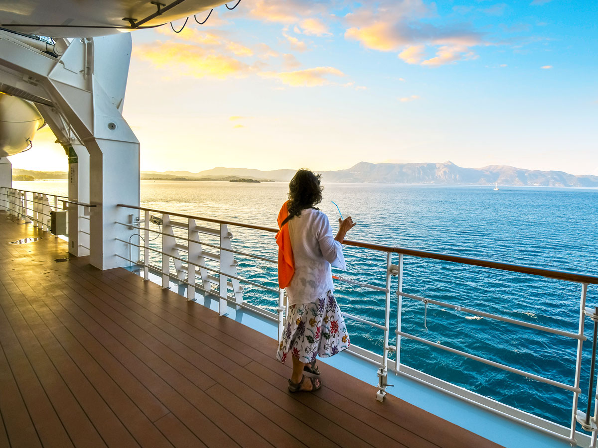 Person on cruise ship balcony looking out at sea