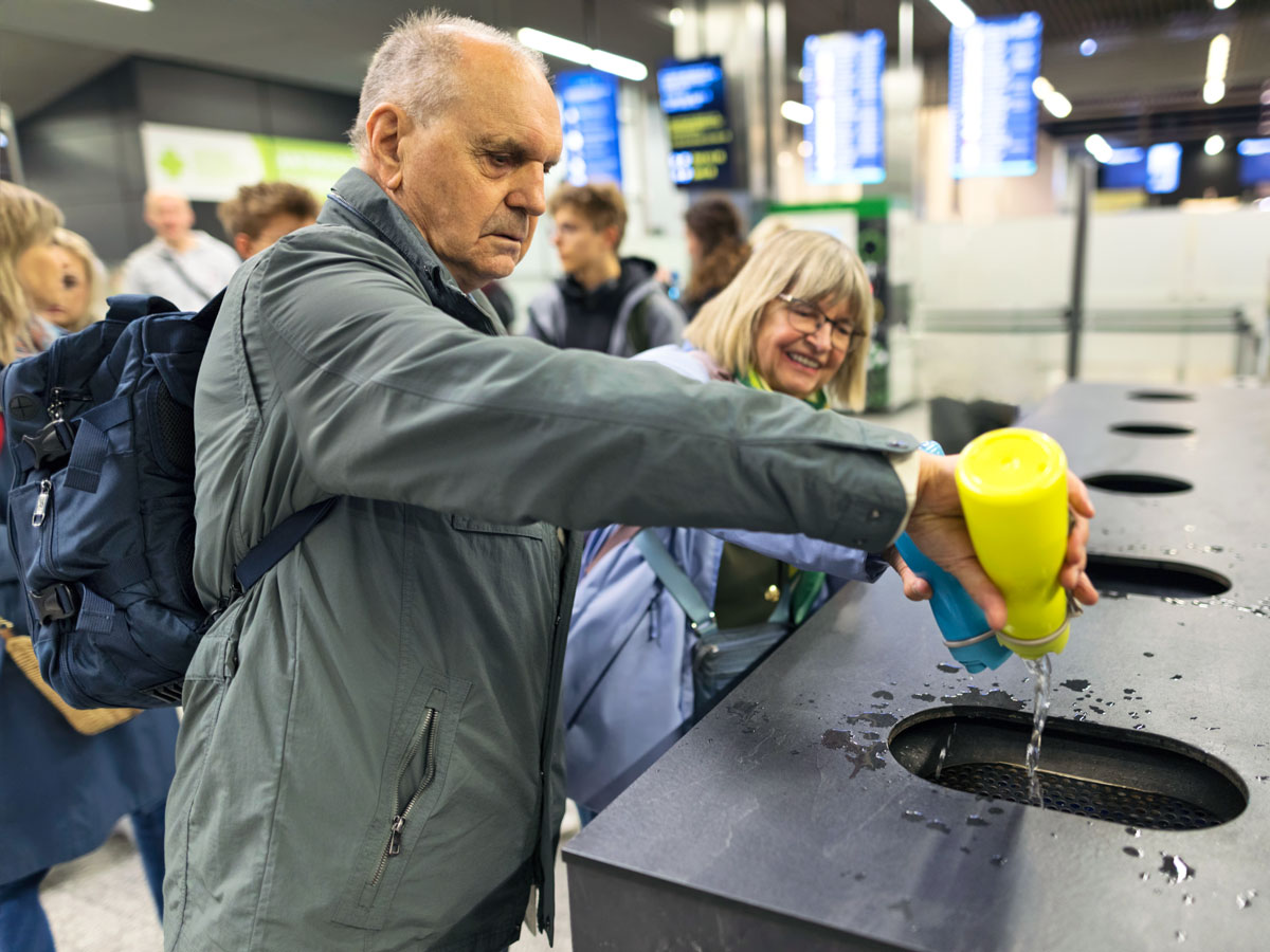 Traveler dumping liquids at airport security checkpoint