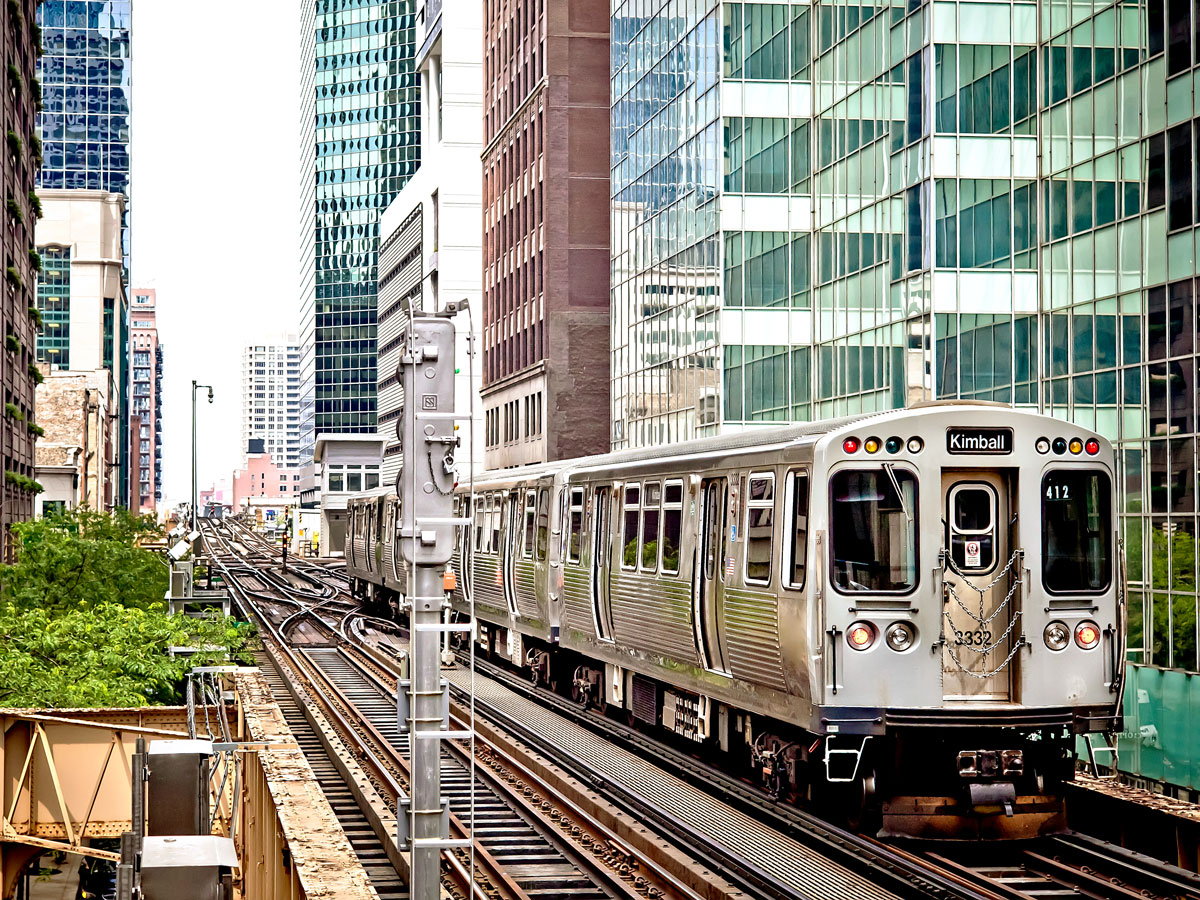 Chicago's "L" train on elevated tracks between high-rises
