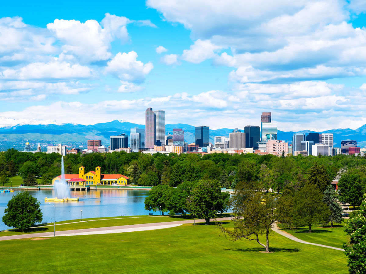 Aerial view of park, Denver skyline, and mountains in distance