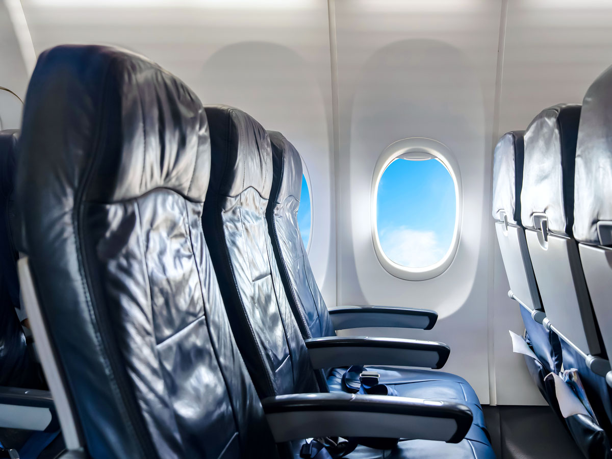 Row of three empty airplane seats