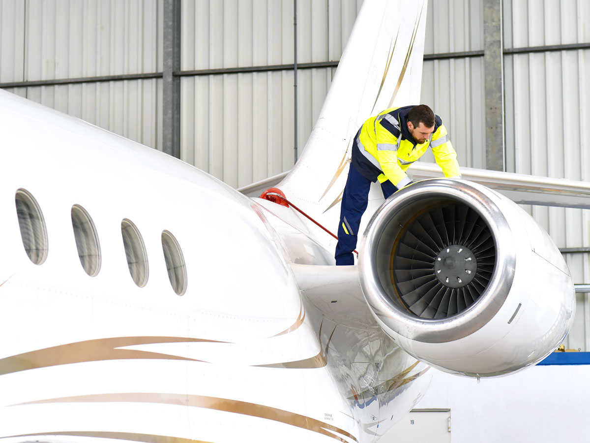 Mechanic inspecting aircraft engine