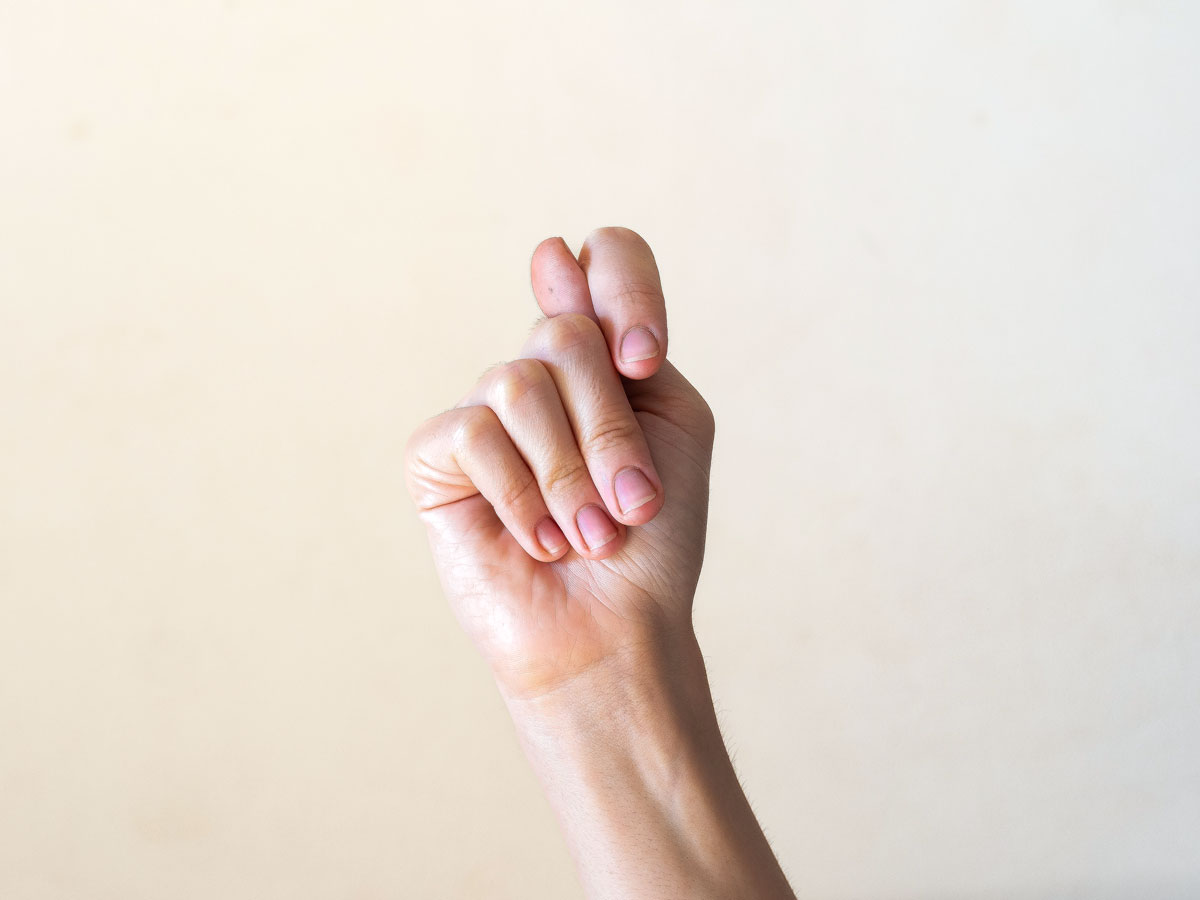 Person making the fig gesture
