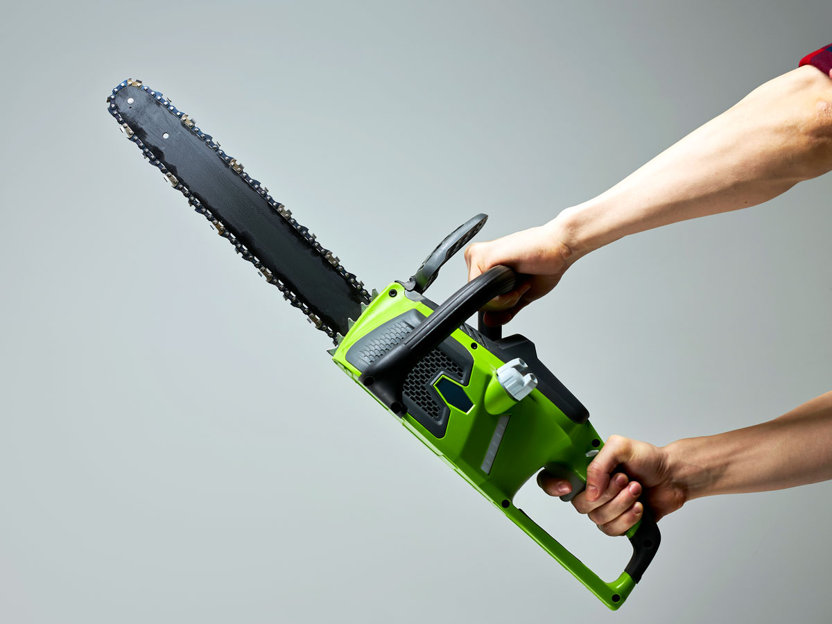 Person holding chainsaw