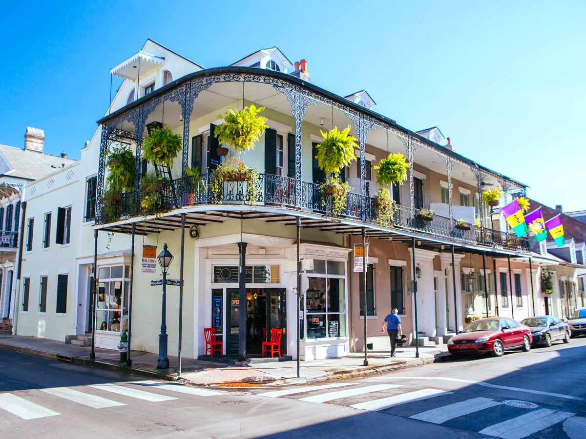 Two-story building with wrought-iron balcony in New Orleans 
