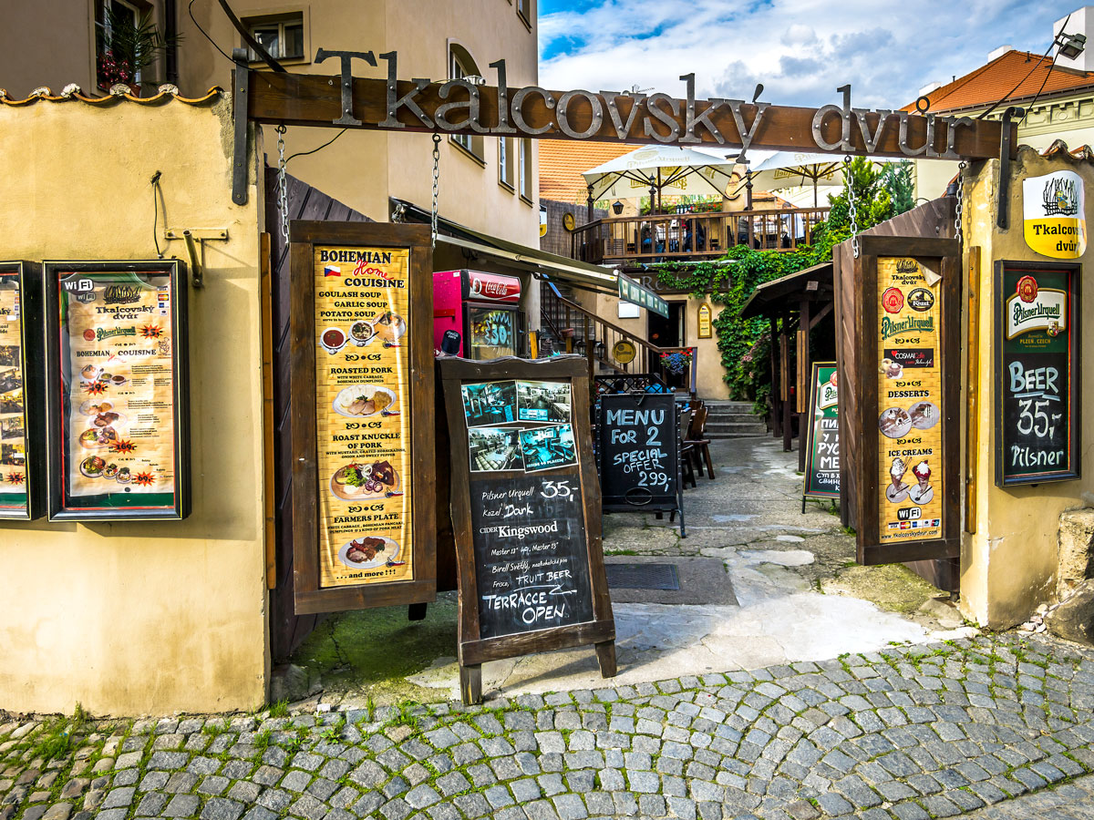 Signs advertising beer and food in Prague