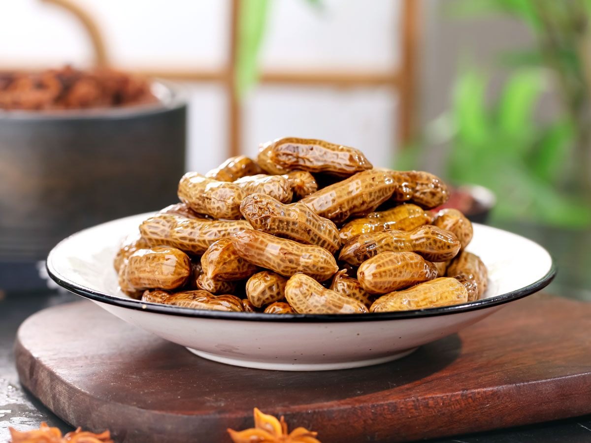 Bowl of boiled peanuts on countertop
