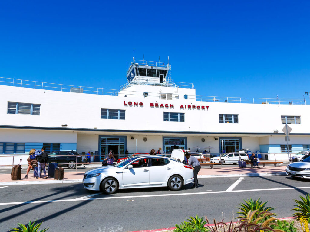 Curbside drop-off zone and historic terminal building at Long Beach Airport in Southern California