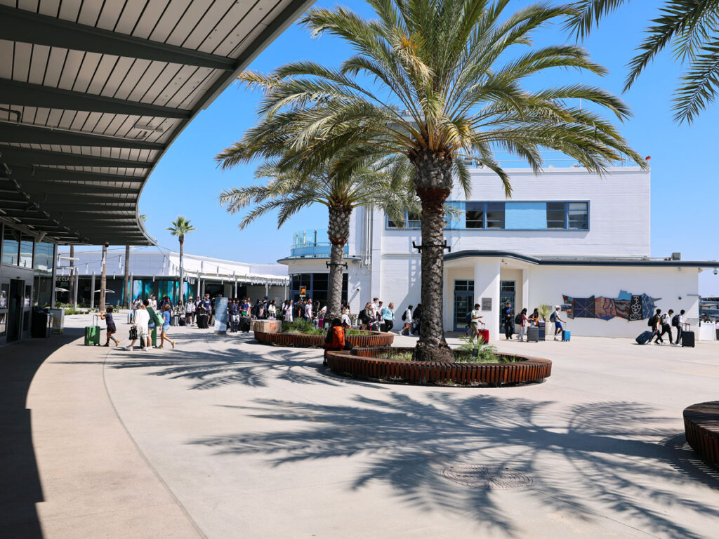 Passengers transiting the indoor-outdoor terminal area at Long Beach Airport