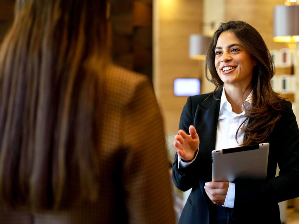 Guest speaking to hotel employee