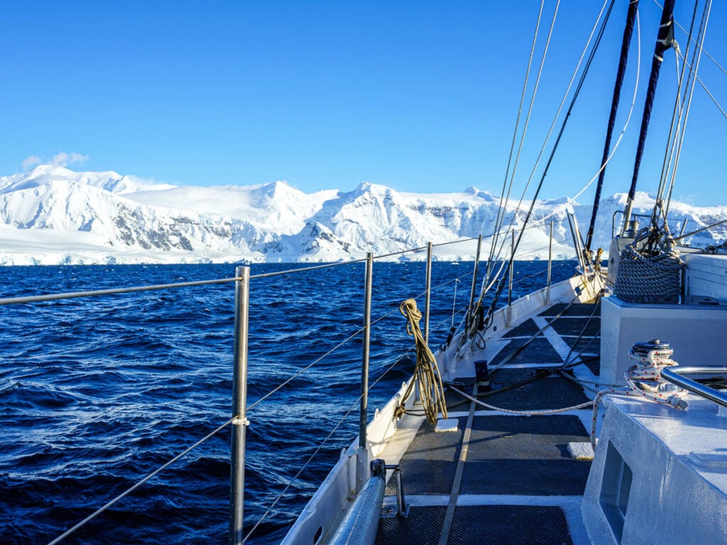 View from ship deck of snow-covered Antarctica coastline