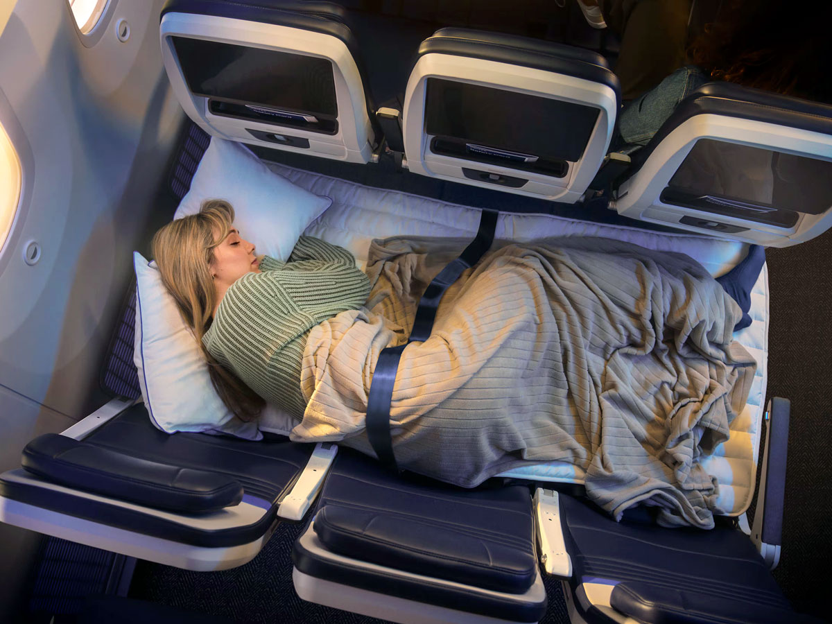 Traveler sleeping in United Relax Row