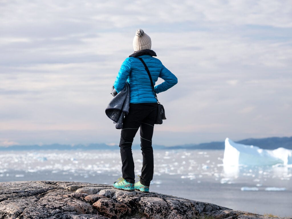Traveler viewing icebergs off the coast of Antarctica