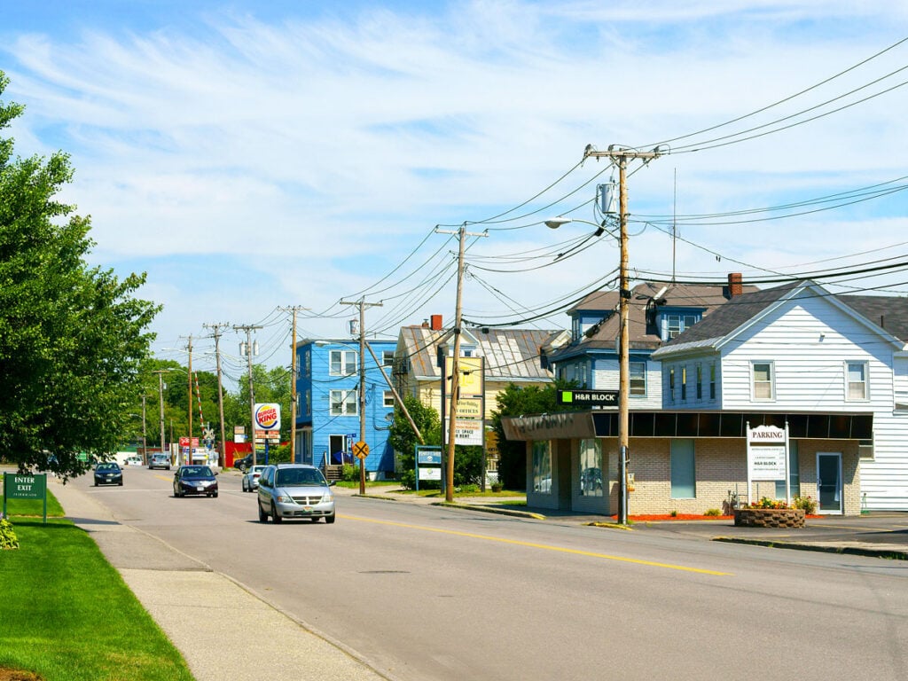 Cars driving down street in Waterville, Maine